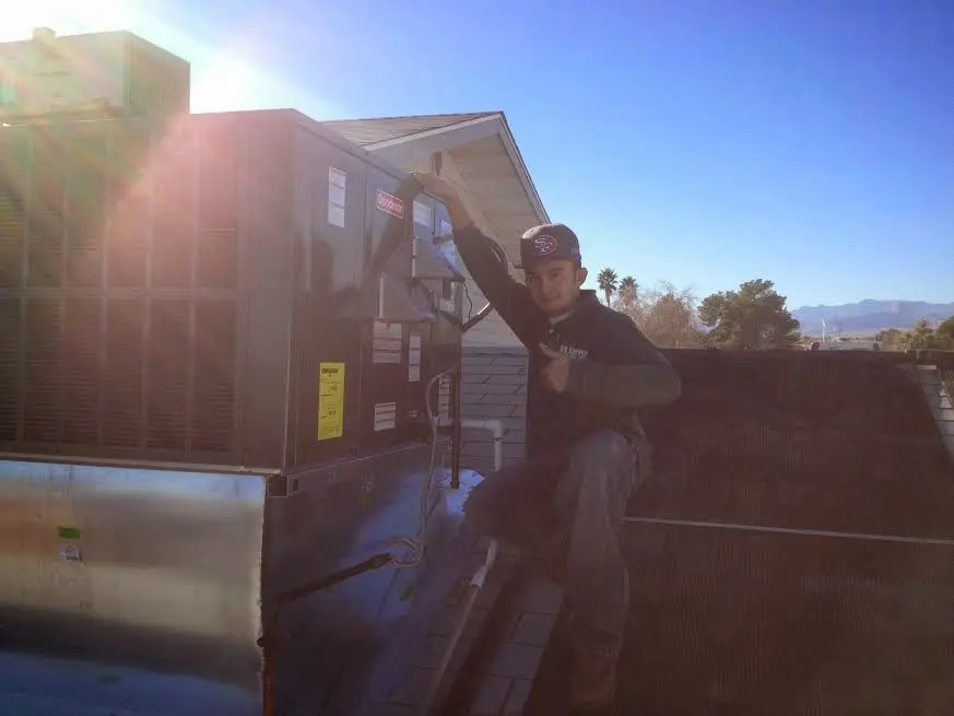 HVAC technician performing HVAC Inspection on a rooftop unit in Powell